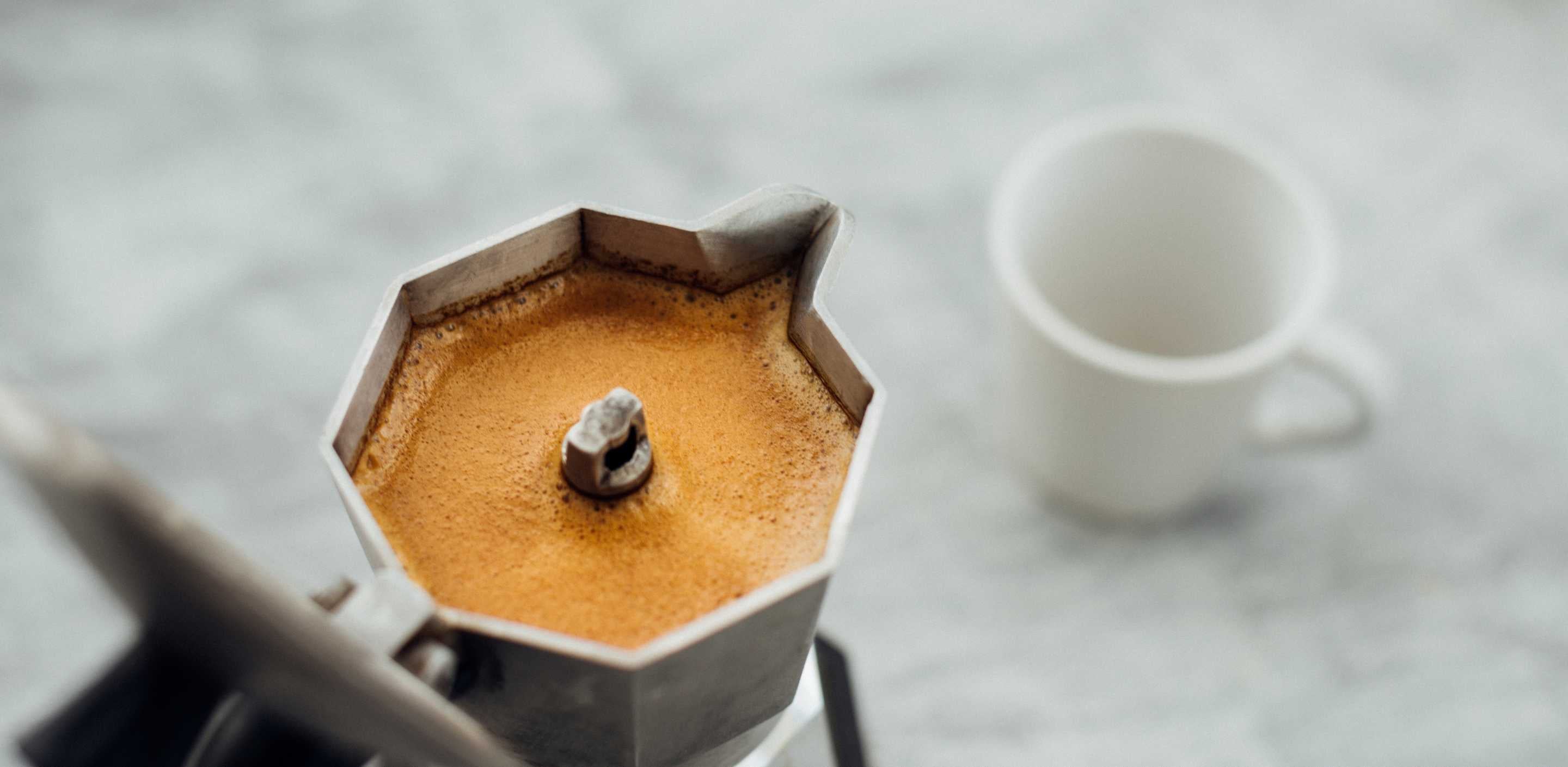 full moka-pot vs espresso with cup next to it