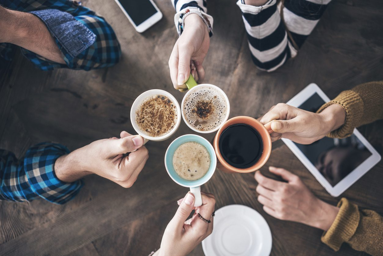 A circle of warm cups of coffee. 