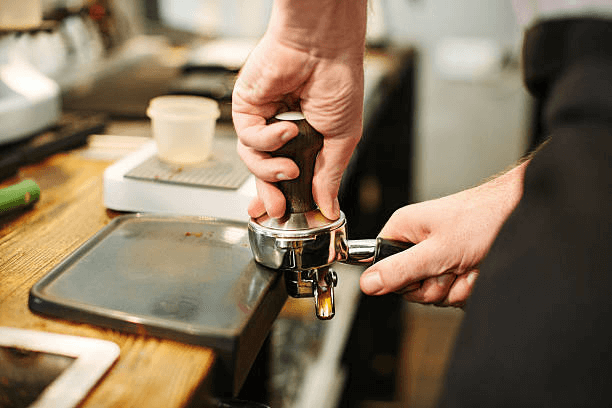 A coffee puck ready to tamp espresso. 