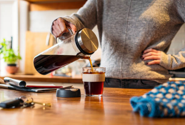 woman pouring cold brew into glass